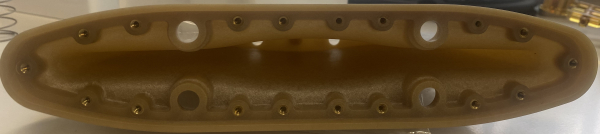 Ultem-based part with 18 brass inserts manufactured by HiTech Plastics and Molds